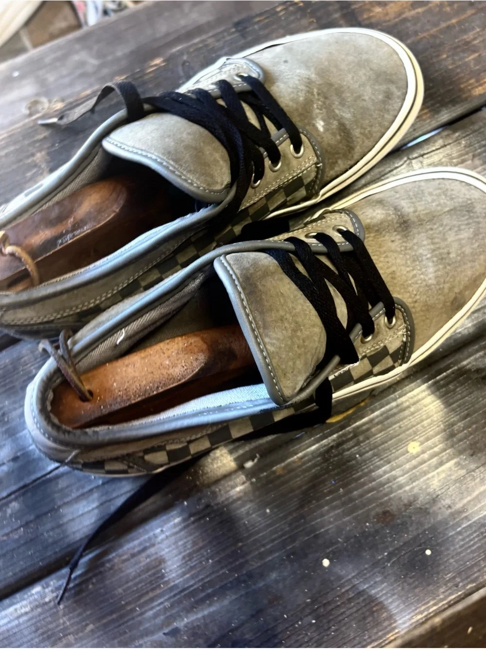 Vans gray suede sneakers with black & white checkerboard pattern on the side